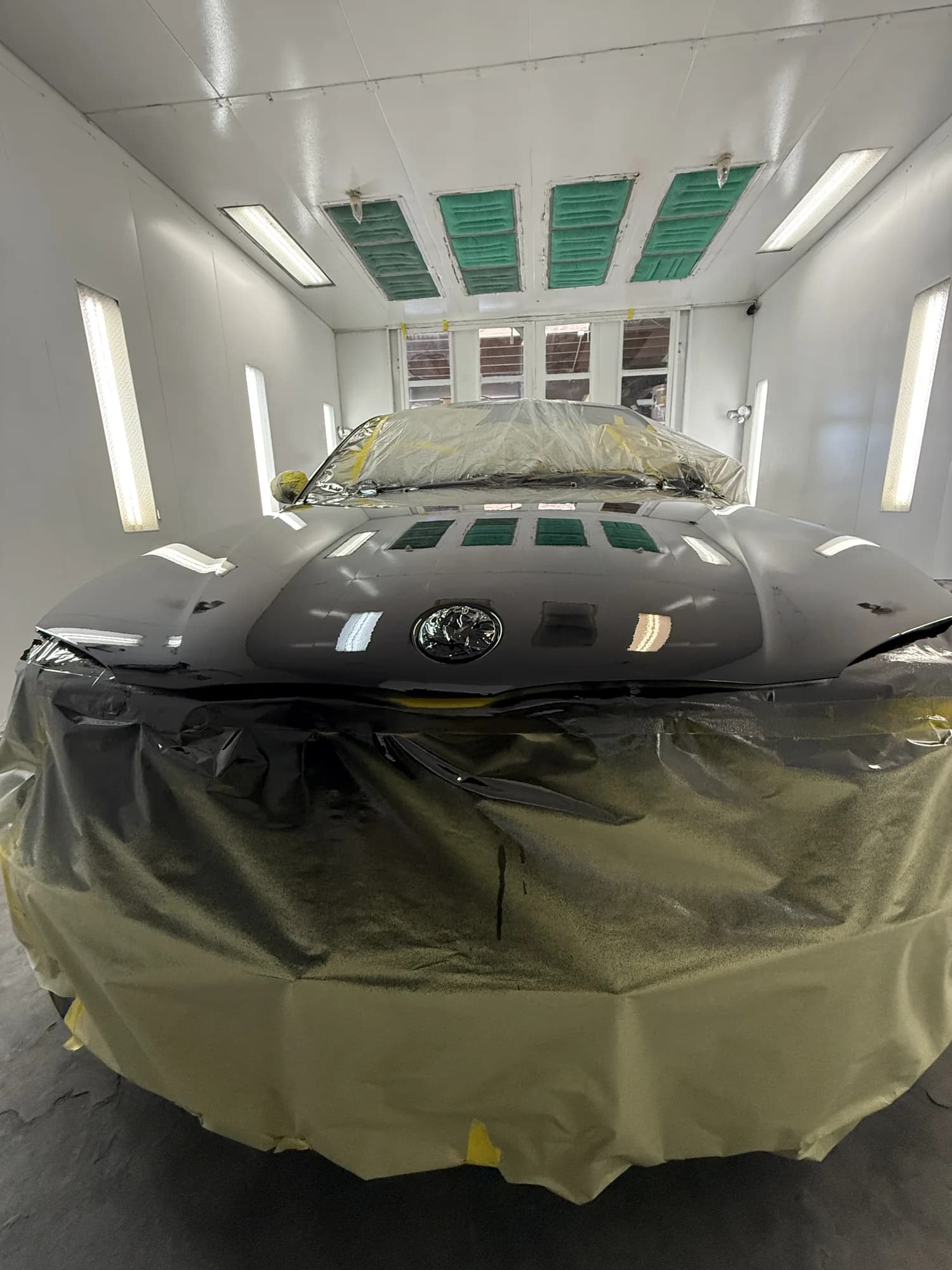 Vehicle fully masked and sealed inside the downdraft paint booth