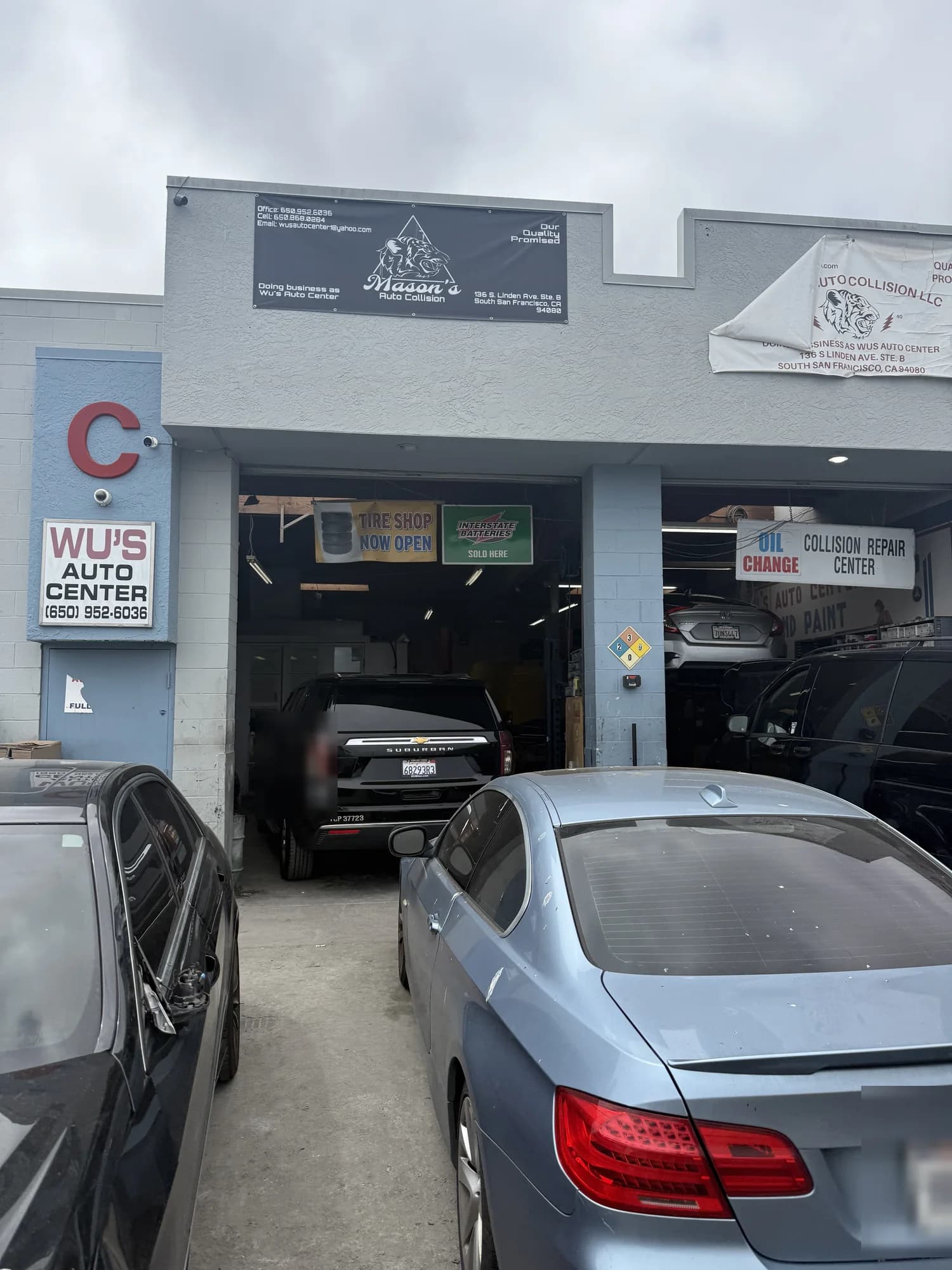 Wu's Auto Center repair bays with vehicles waiting
